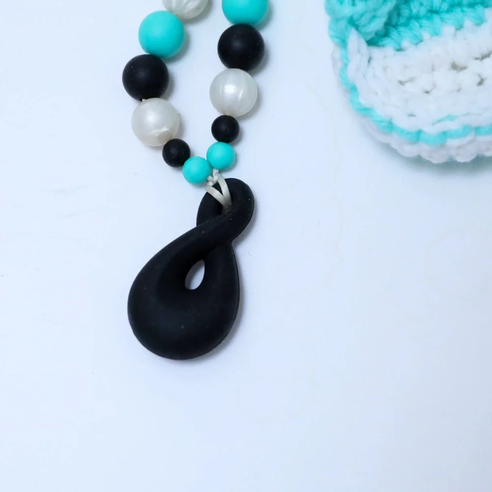 Set of crocheted baby shoes and teal baby teething necklace chewy shower newborn